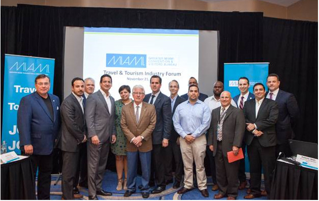 William D. Talbert III, CDME, President & CEO of the Greater Miami Convention & Visitors Bureau (Center tan jacket) and Rolando Aedo, Executive Vice President and Chief Marketing Officer of the Greater Miami Convention & Visitors Bureau (Blue suit directly behind William) in partnership with Paul Phipps, Chief Marketing Officer of Visit Florida and President and Chief Operating Officer of Fontainebleau Miami Beach hosted a Travel & Tourism Forum at Fontainebleau Miami Beach with industry leaders this week to develop best practices for dealing with mosquito borne-illnesses. 