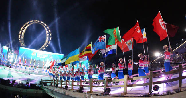3 of 10<br />Flag bearers marched during the opening ceremony, holding flags from participating nations. More than 105 countries, 10 international organizations, and a handful of corporate entities have constructed experiential pavilions for Expo 2012.