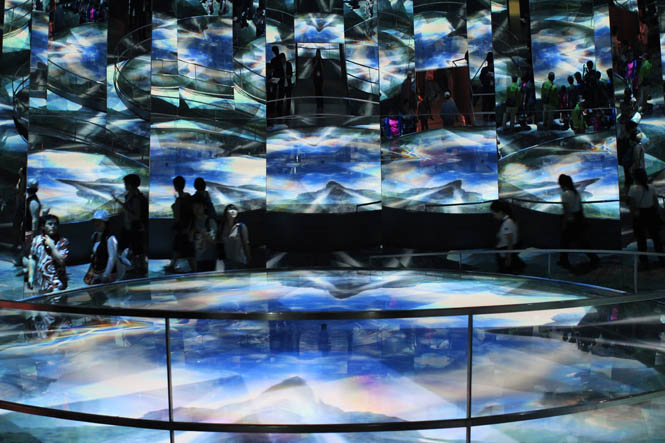 The Switzerland Pavilions so-called Source Room is a circular enclosure with mirrors covering the walls at fractured angles. Four projectors flash a 4.5-minute movie on a 30-foot-diameter pool in the middle, showing water as a source of both joy and responsibility.