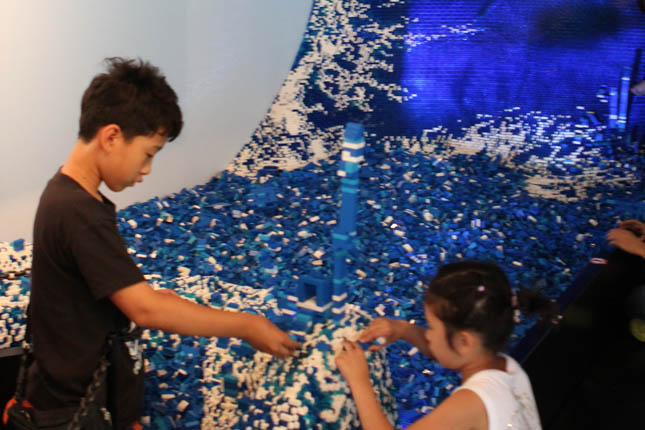 The main attraction of the Denmark Pavilion is a tidal-wave-shaped structure made of 685,000 Legos, which visitors could add to by grabbing from a pile of thousands of blue and white pieces. The structure, meant to represent the wave of creativity, took 1,318 hours to build.