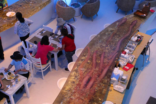 Inside the Peru Pavilion, we dined on ceviche and spiced chicken, eased down by Pisco sours  and all served on a bar where a replica of a giant squid is encased in an acrylic block. Its headlight-sized eye watches you as if it would prefer that you be dinner than have dinner.