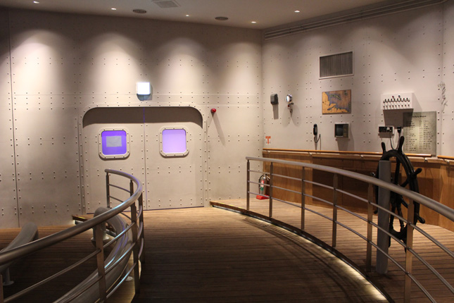 The first of two immersive theater experiences inside the Russia Pavilion takes place in a ship-inspired space meant to represent an atomic ice breaker, complete with rivets, portholes, and a captains wheel.
